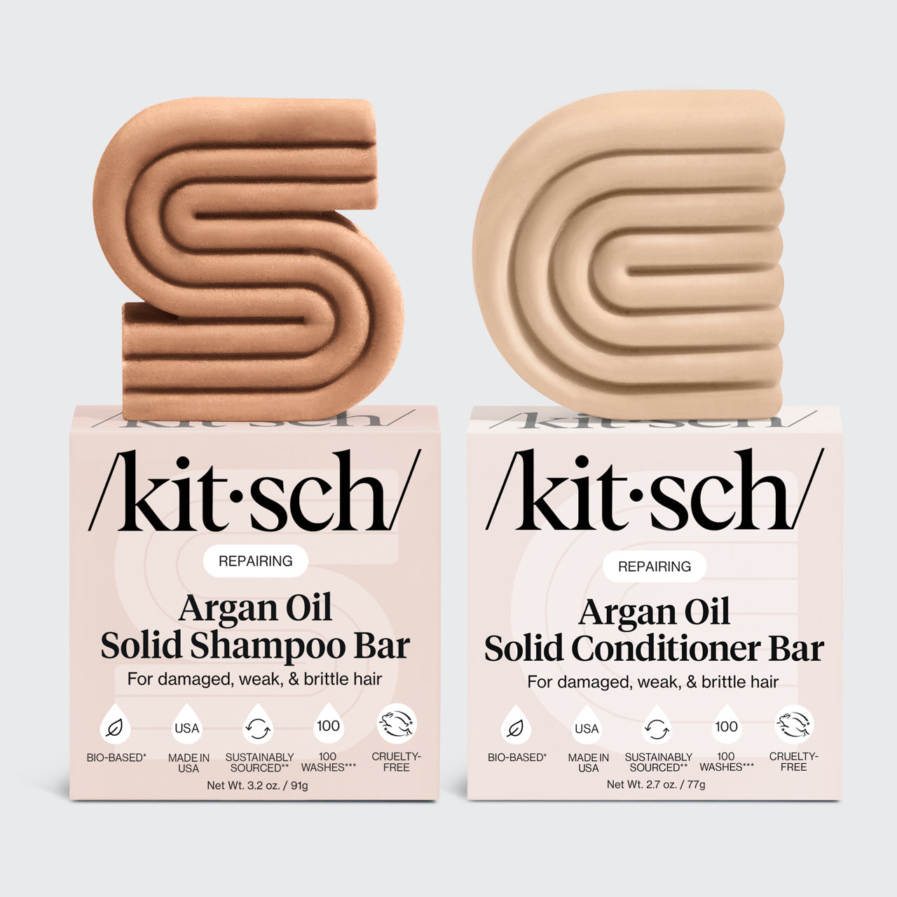 KITSCH Repairing Argan Oil Shampoo & Conditioner Bar Combo — hero product shot on light gray background — REPAIRING Argan Oil Solid Shampoo Bar and Conditioner Bar with retail boxes — For damaged, weak, & brittle hair — Bio-based | Made in USA | Cruelty-Free — Shampoo: Net Wt. 3.2 oz / 91g | Conditioner: Net Wt. 2.7 oz / 77g — Formulated with Everbond® to help reverse and repair hair damage