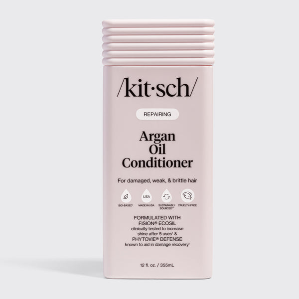 KITSCH Repairing Argan Oil Conditioner 12 fl. oz. — labeled REPAIRING, For damaged, weak, & brittle hair — icons: Bio-Based, Nontoxic, Sustainably Sourced, Cruelty-Free — Formulated with Fision® EcoSil clinically tested to increase shine after 5 uses & PhytoVie® Defense known to aid in damage recovery