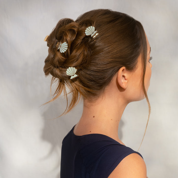 Model's updo hairstyle decorated with 2 Kitsch Gold & Cream Metal Clam Shell Hair Clips – coastal styling