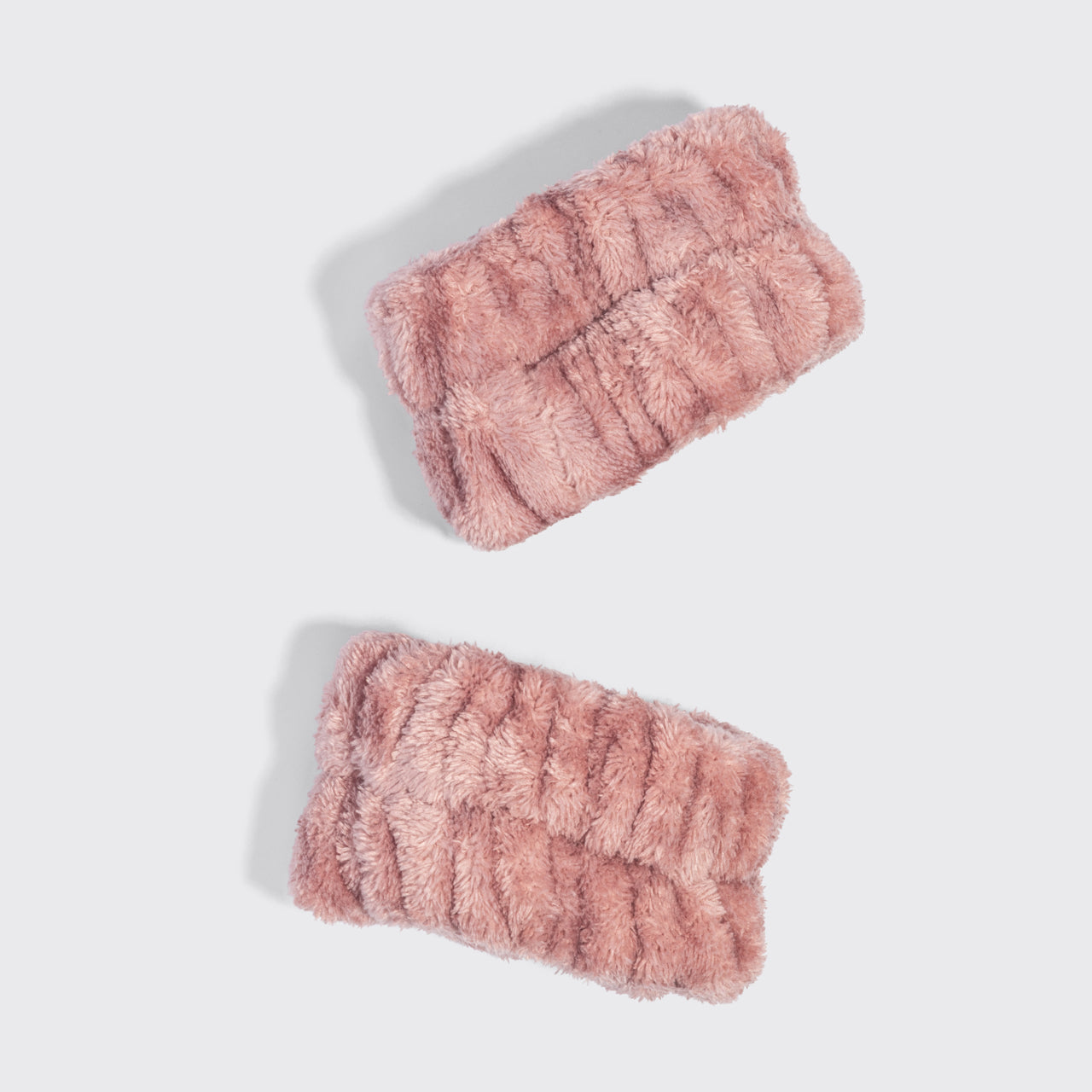 Pair of terracotta Kitsch Spa Wristlets made from ultra-plush recycled microfiber to help keep water from running down the arms while cleansing.