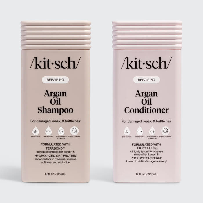 KITSCH Repairing Argan Oil Shampoo 12 fl. oz. & Conditioner 12 fl. oz. Combo — both labeled REPAIRING, For damaged, weak, & brittle hair — icons: Bio-Based, Nontoxic, Sustainably Sourced, Cruelty-Free — Shampoo formulated with Terabond™ & Hydrolyzed Oat Protein; Conditioner formulated with Fision® EcoSil & PhytoVie® Defense