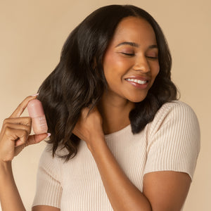 Lifestyle model spraying hair with the Amber Shores Mini Hair Perfume 